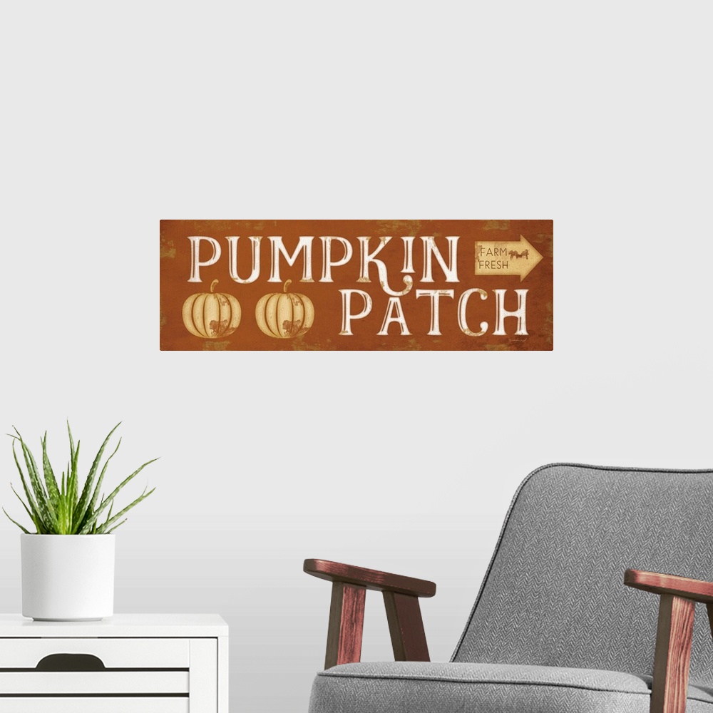 A modern room featuring Fall decor sign with the words, "Pumpkin Patch" and an arrow to mark direction.