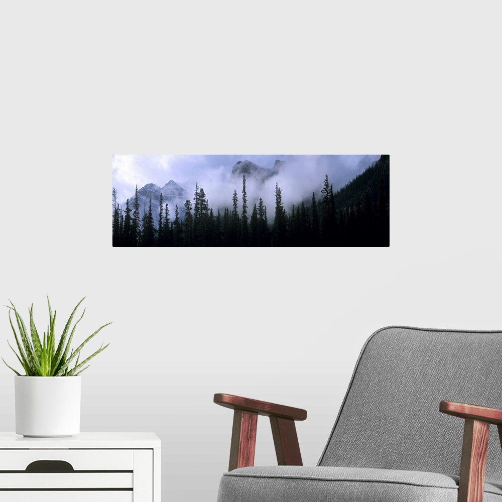 A modern room featuring Canada, Alberta, Banff NP. Clouds swirl around mountain peaks above Lake Louise Junction in Banff...