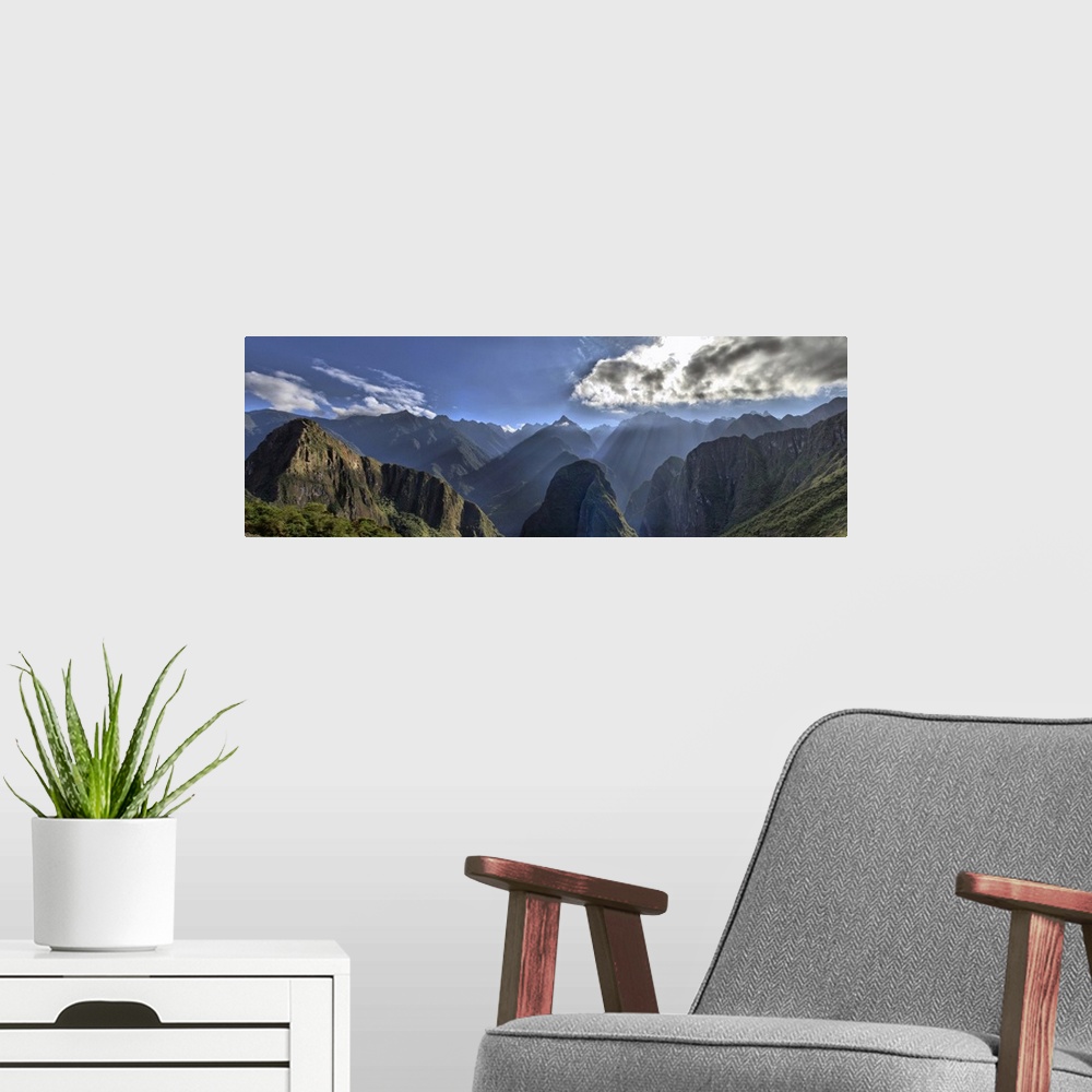 A modern room featuring View of Andes Mountain Range from Machu Picchu. Beautiful scenery with sun rays shining through t...