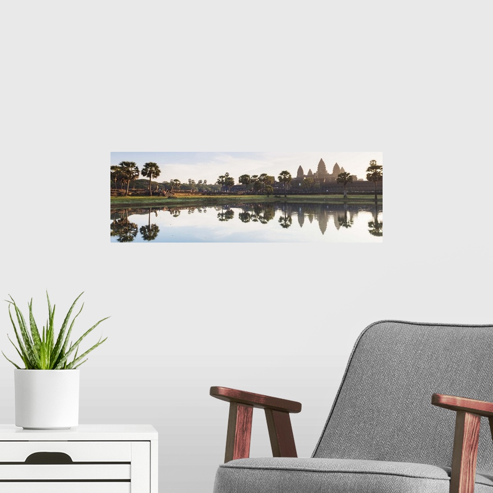 A modern room featuring Cambodia, Siemreab, Angkor, Sunset across the moat to the Angkor Watt.