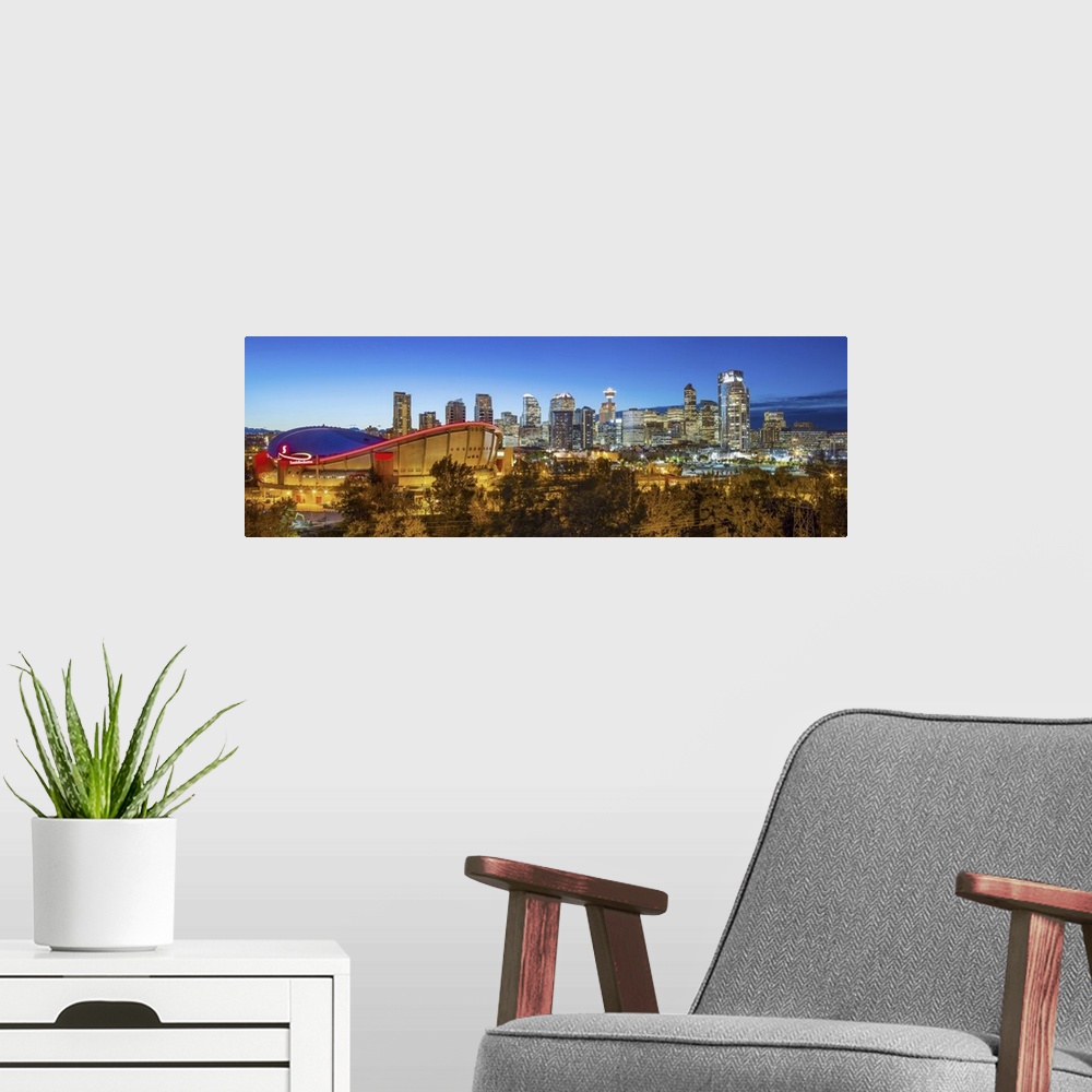 A modern room featuring Canada, Alberta, Calgary, Skyline of downtown Calgary and Saddledome illuminated at dusk.