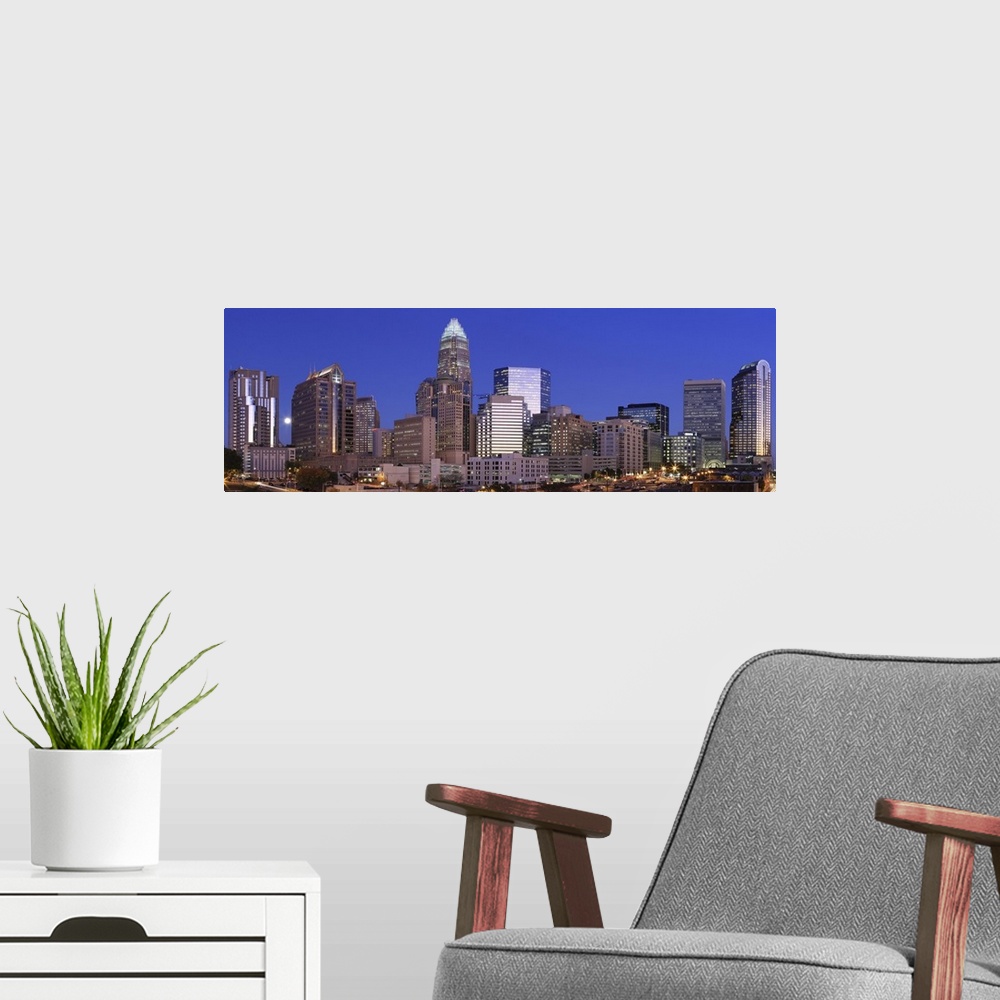 A modern room featuring Panorama of Charlotte, North Carolina skyline at dusk