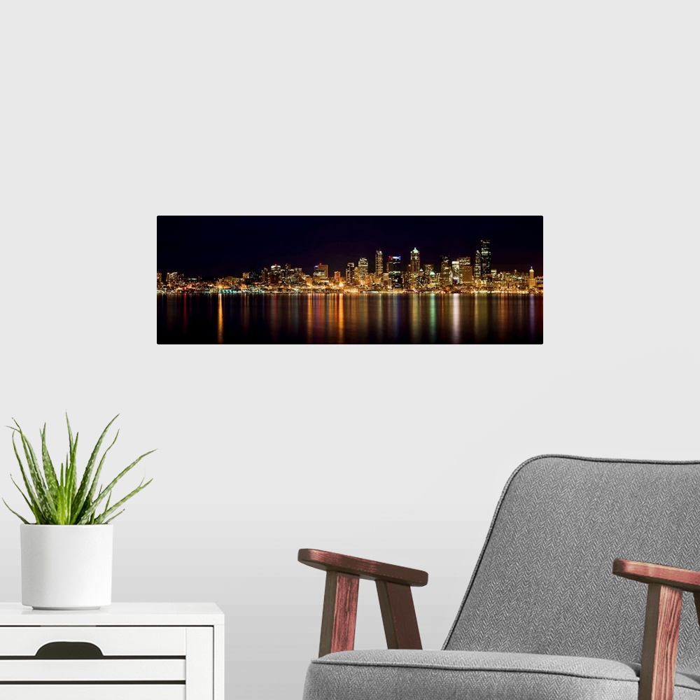A modern room featuring Nighttime shot of downtown Seattle at night with lights of city reflected in water of Puget Sound.