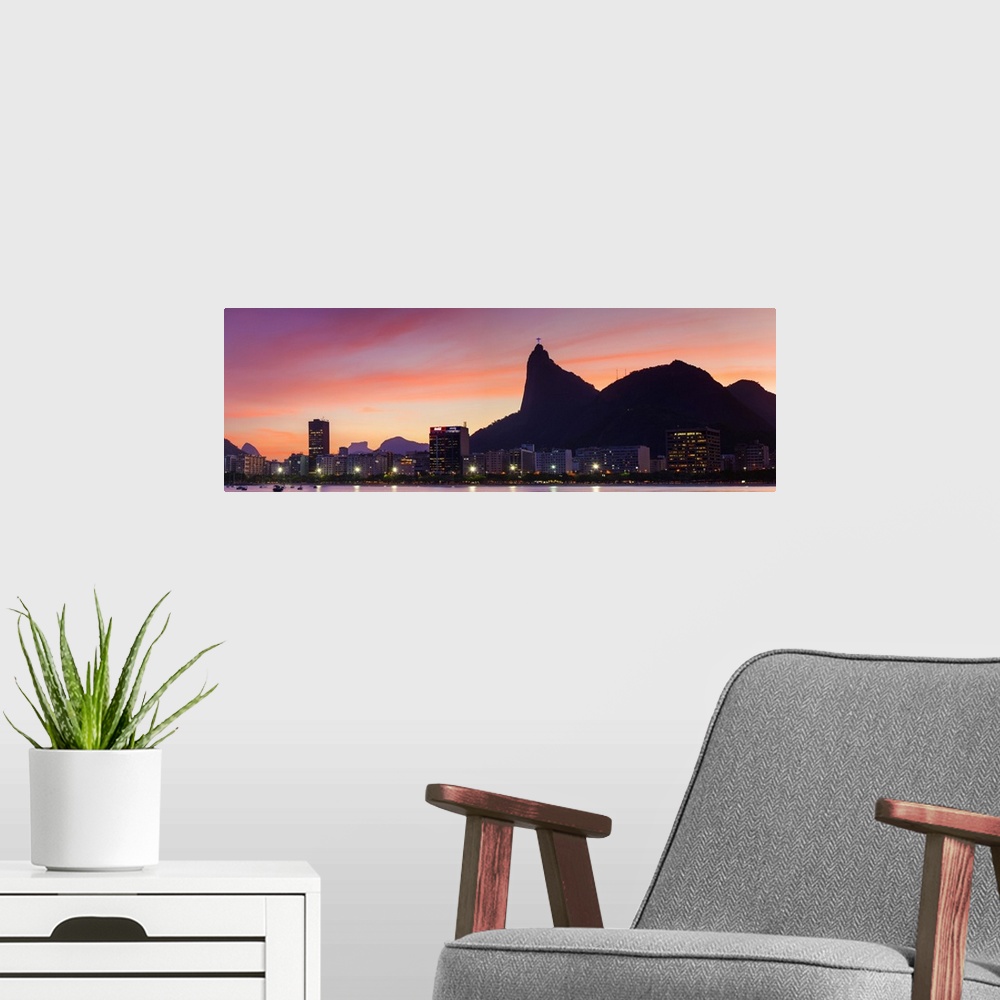 A modern room featuring Botafogo Bay and Christ the Redeemer statue at sunset, Rio de Janeiro, Brazil