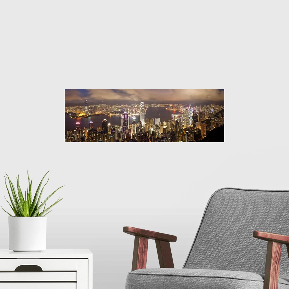 A modern room featuring China, Hong Kong, Victoria Peak. View over Hong Kong from Victoria Peak. The illuminated skyline ...
