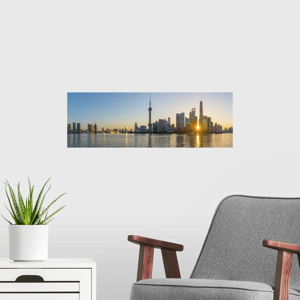 A modern room featuring China, Shanghai, Pudong District, Skyline of the Financial District across Huangpu River at sunrise