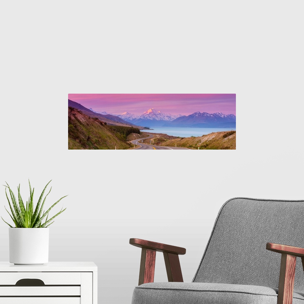 A modern room featuring Mount Cook (Aoraki) illuminated at sunset, Lake Pukaki, Mackenzie Country, Canterbury, South Isla...