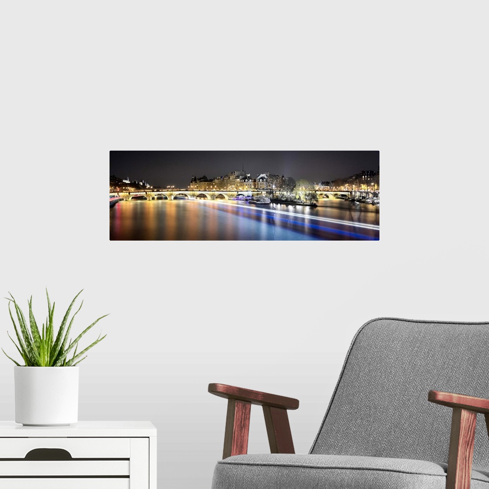 A modern room featuring Night long time exposure view of Paris from pont des arts bridge on Seine river with lignting bri...
