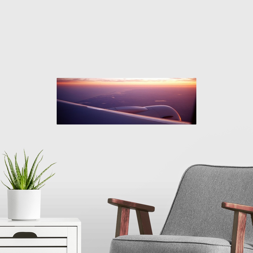 A modern room featuring Airplane wing at dusk