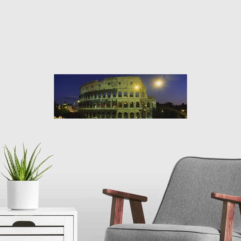 A modern room featuring A panorama of the Roman Colosseum at night, with emphasis on the facade.