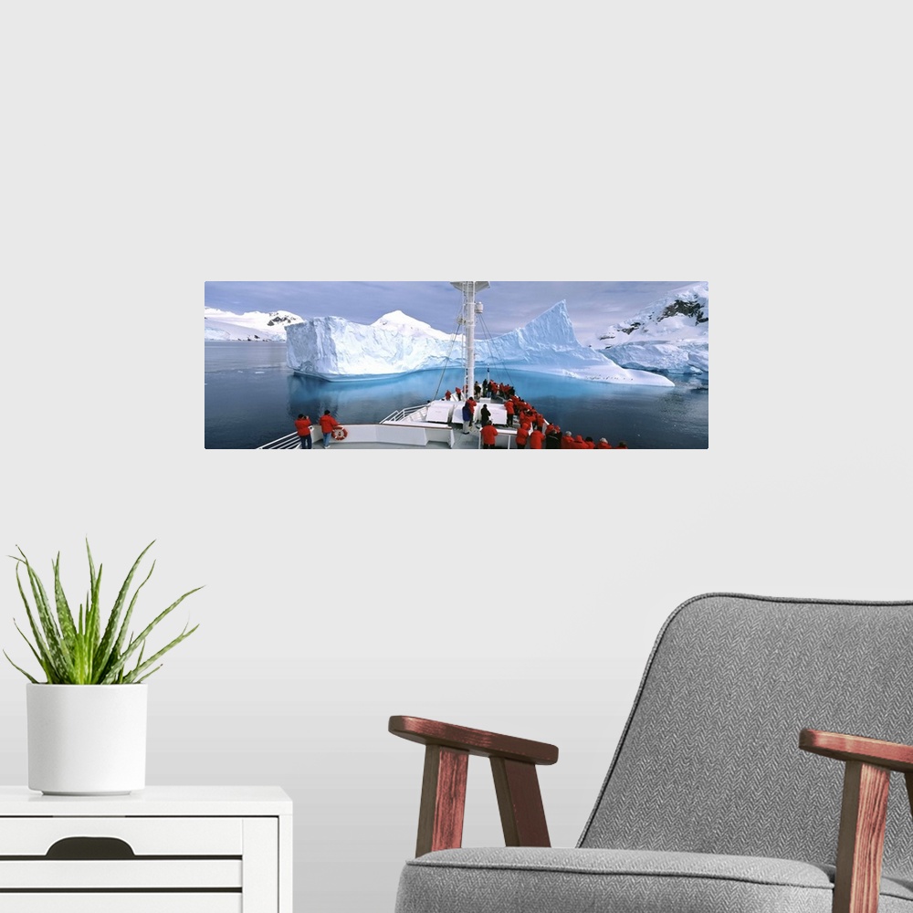 A modern room featuring Antarctica, Antarctic Peninsula, Tourists standing on a cruise ship watching at iceberg