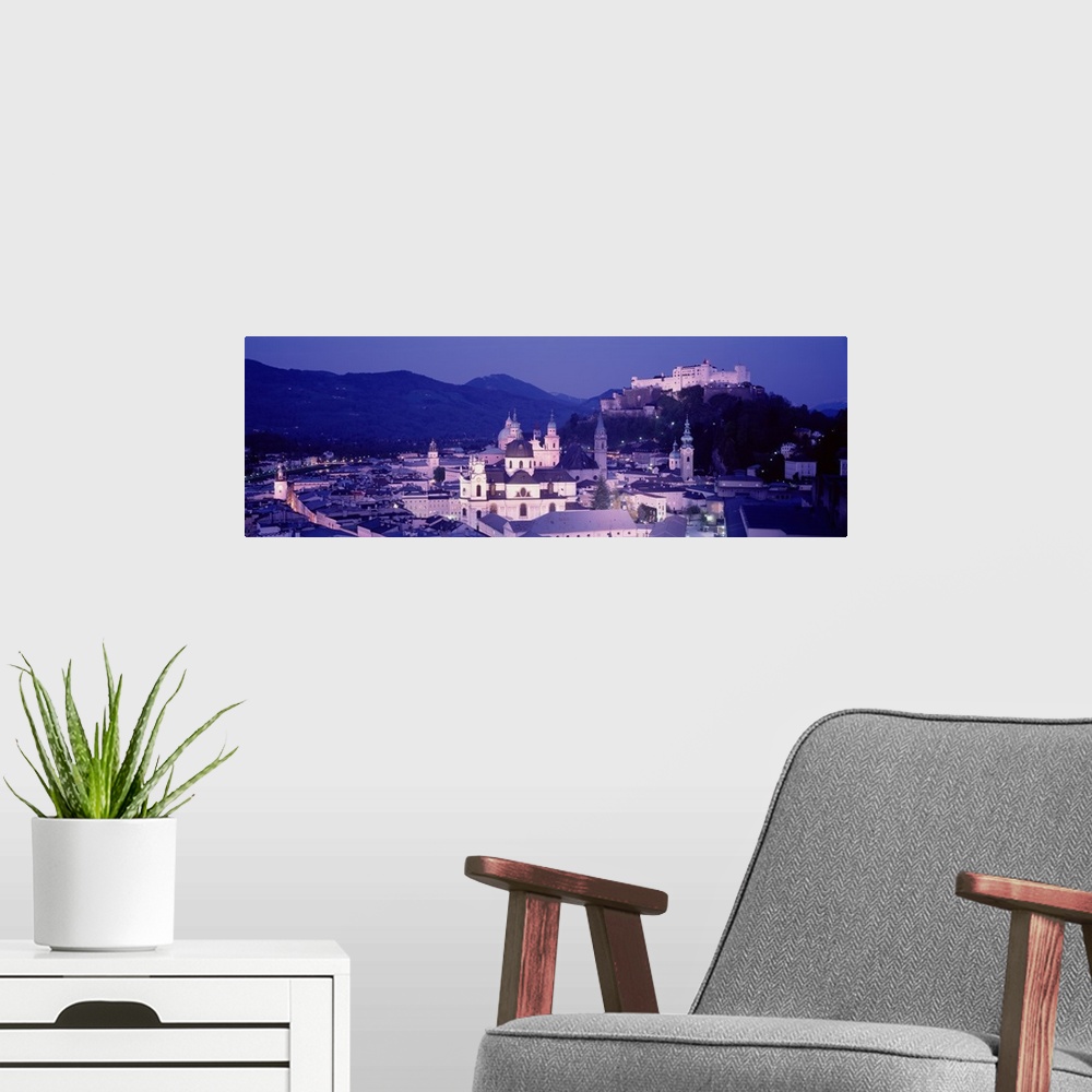 A modern room featuring Austria, Salzburg, Panoramic view of the city in dusk