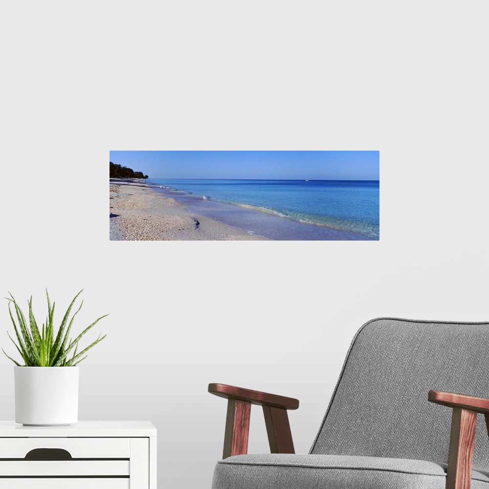 A modern room featuring Horizontal canvas photo of calm waves rolling ashore from the Gulf of Mexico.