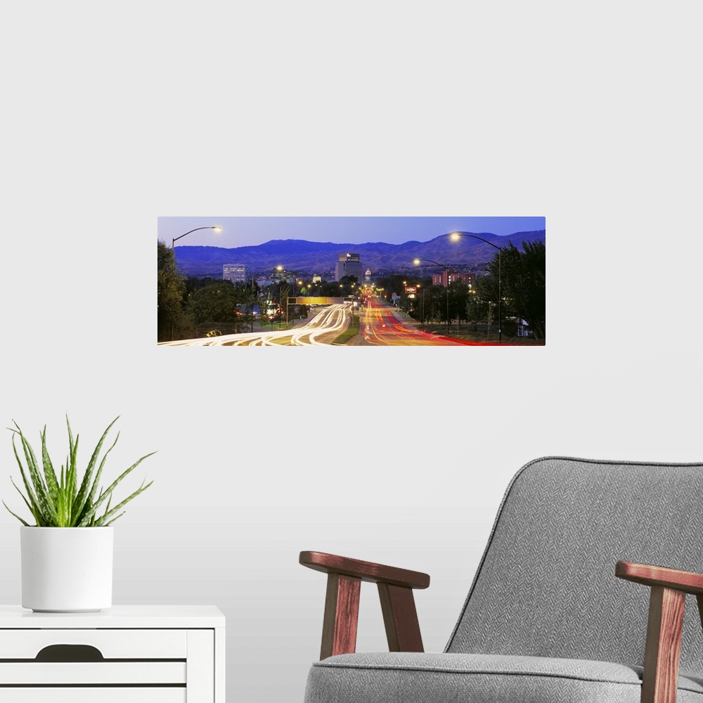 A modern room featuring Panoramic photograph taken of a major highway in Boise with the lights of the cars shown as strea...