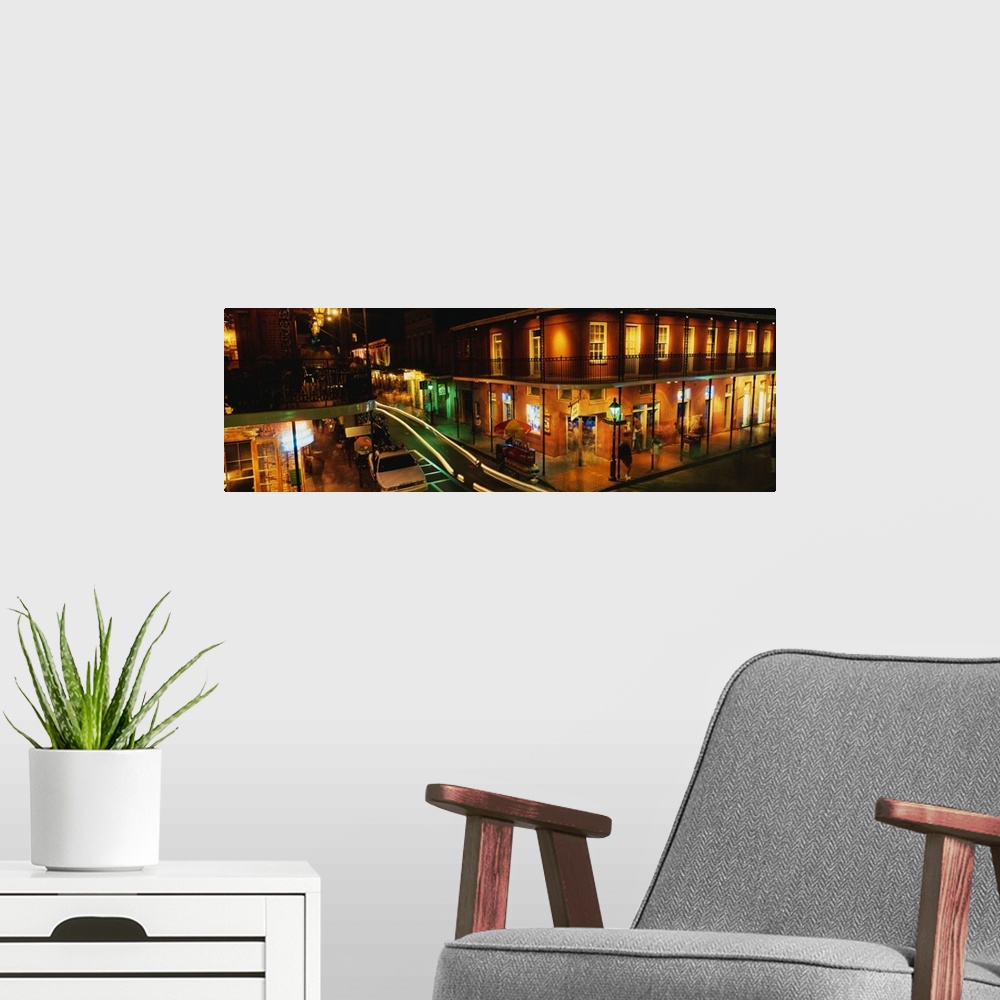 A modern room featuring Panoramic photograph displays a nighttime view of the busy streets within the French Quarter loca...