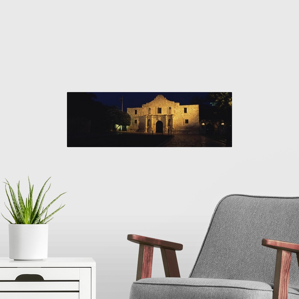 A modern room featuring A night panorama of the Alamo in San Antonio Missions National Historical Park in Texas.