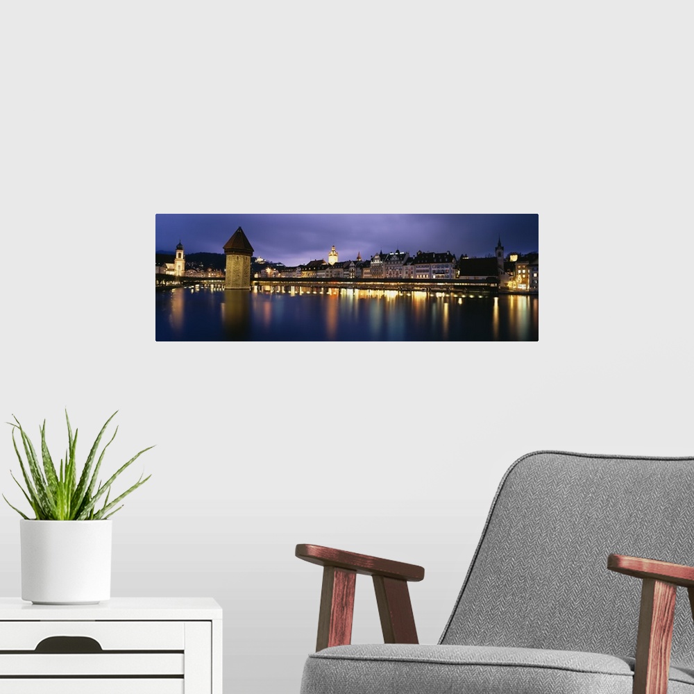 A modern room featuring Buildings lit up at dusk, Chapel Bridge, Reuss River, Lucerne, Switzerland