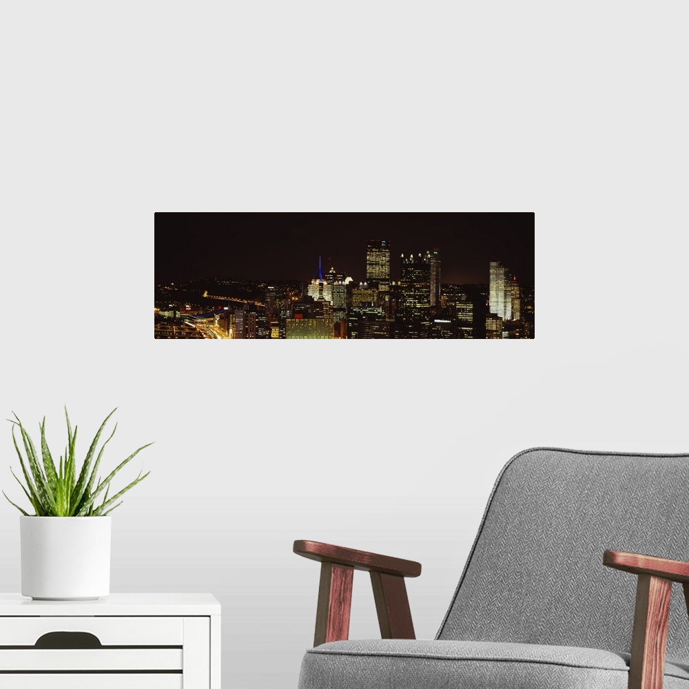 A modern room featuring Horizontal, big, high angle photograph of the Pittsburgh skyline, with brightly lit buildings at ...