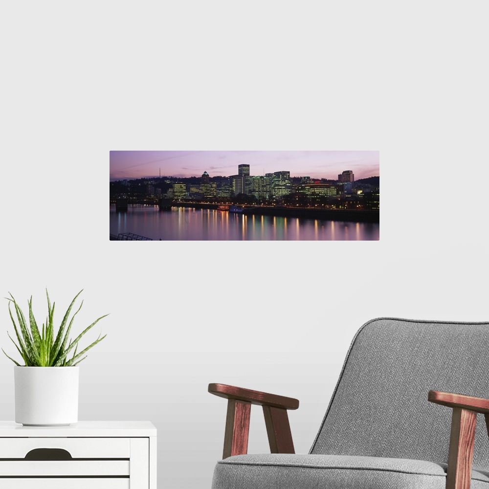 A modern room featuring This is a cityscape glowing in the evening light and reflecting in the surface of the water in th...