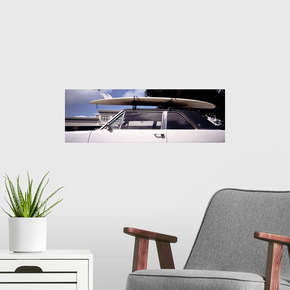 A modern room featuring California, Surf board on roof of car