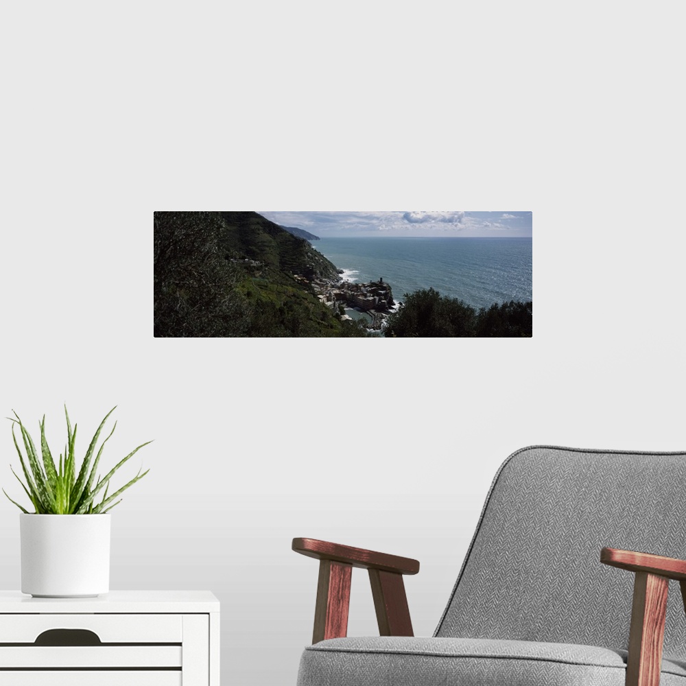 A modern room featuring Panoramic image of an Italian cliff leading to a city by the ocean on canvas.