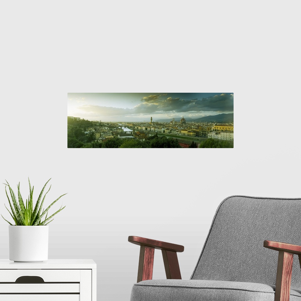 A modern room featuring Panoramic photograph taken from an aerial view overlooking a busy city within Europe.  In the dis...
