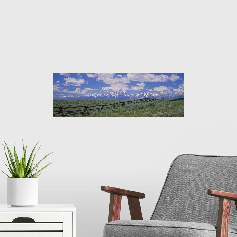 A modern room featuring Clouded sky over snow covered mountains, Grand Teton, Grand Teton National Park, Wyoming