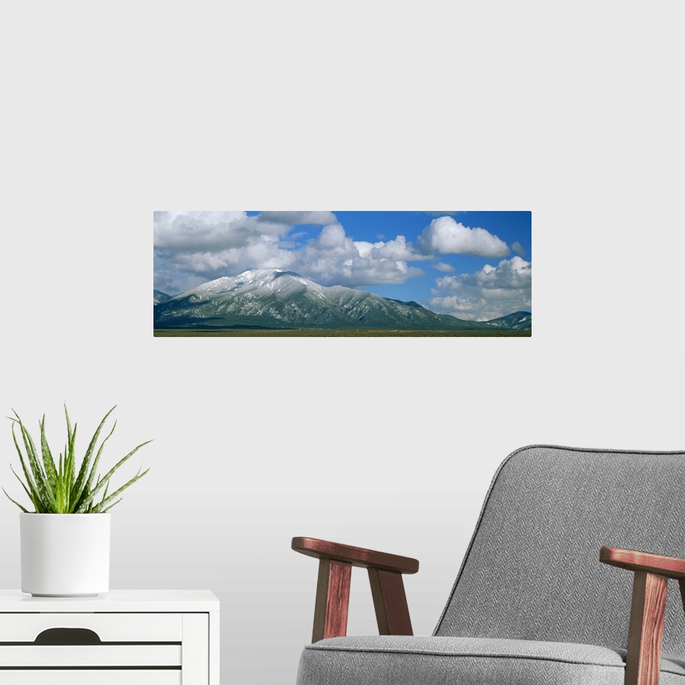 A modern room featuring Clouds over snowcapped mountains, Taos, New Mexico