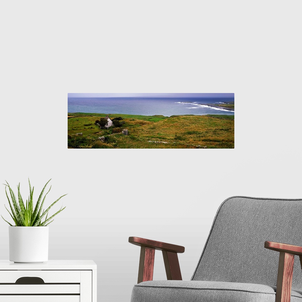 A modern room featuring Coastal landscape with white stone house, Galway Bay, The Burren region, Ireland