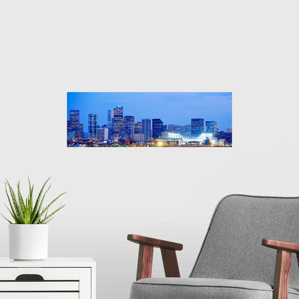 A modern room featuring A panoramic skyline photograph showing city lit up at night.