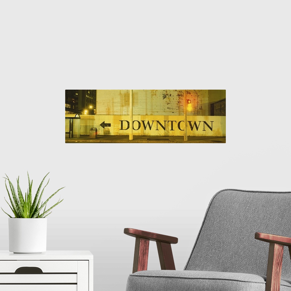 A modern room featuring Large panorama of a half wall in downtown San Francisco with a painted sign on it pointing pedest...