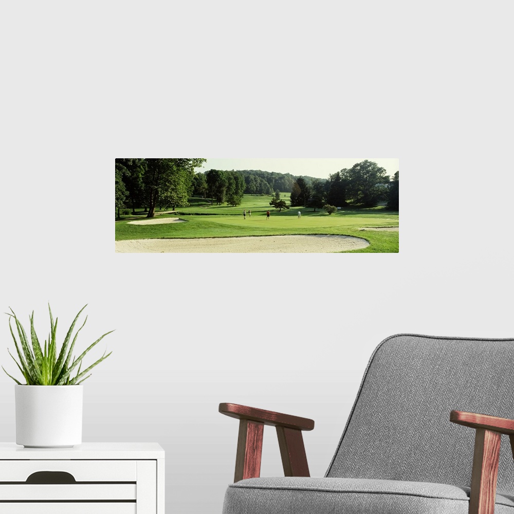 A modern room featuring Four people playing on a golf course, Baltimore County, Maryland