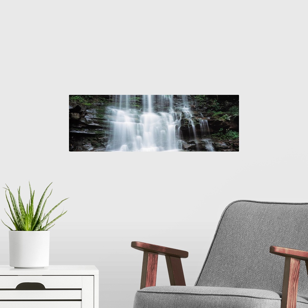 A modern room featuring Panoramic photo on canvas of water rushing down a rocky cliff in Pennsylvania.