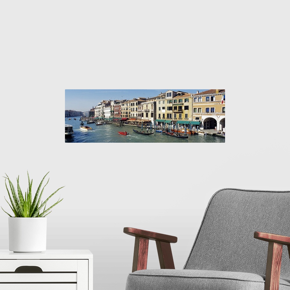 A modern room featuring Buildings that line part of the Grand Canal are pictured in wide angle view with various types of...