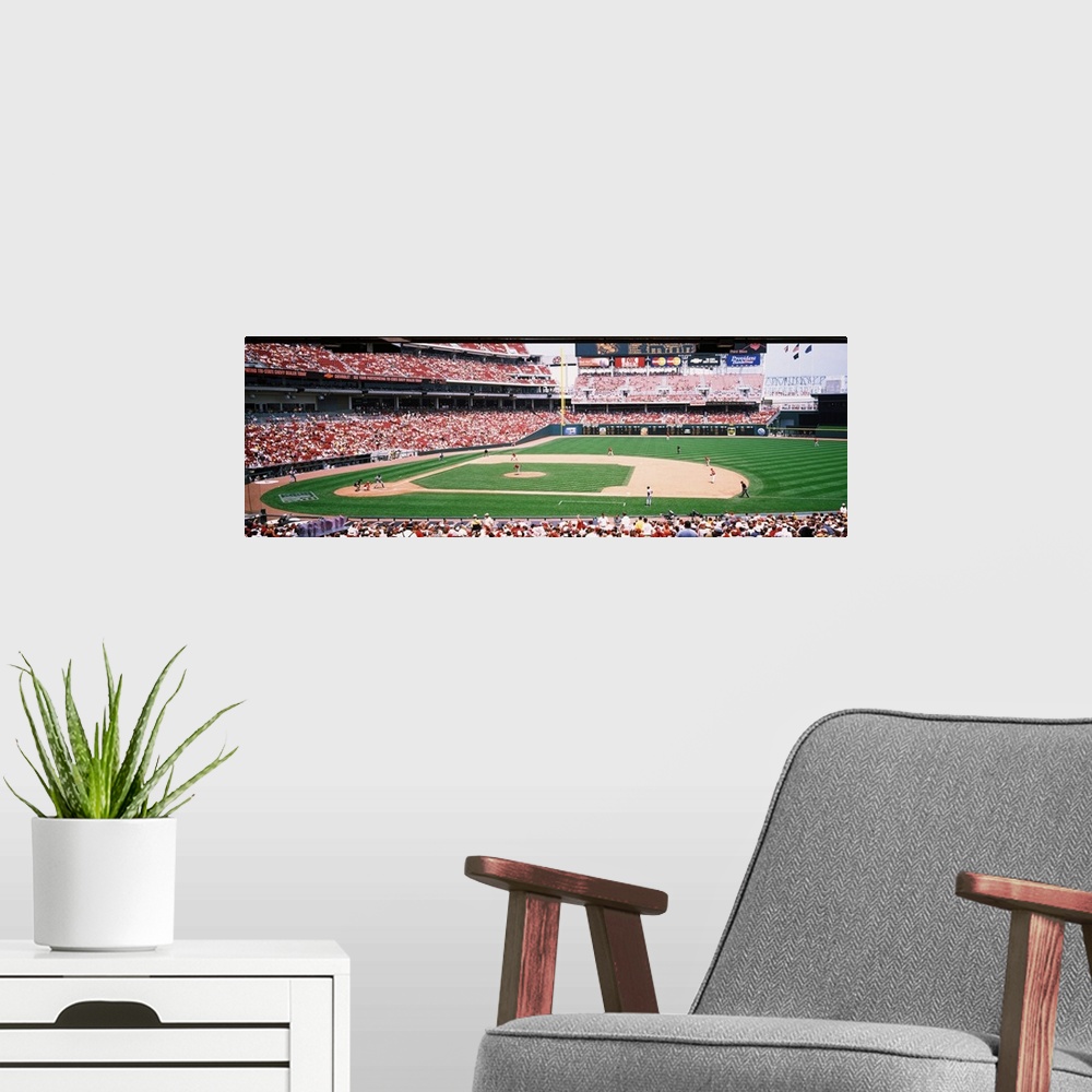 A modern room featuring Long horizontal image of a baseball game being played as spectators watch in Ohio.