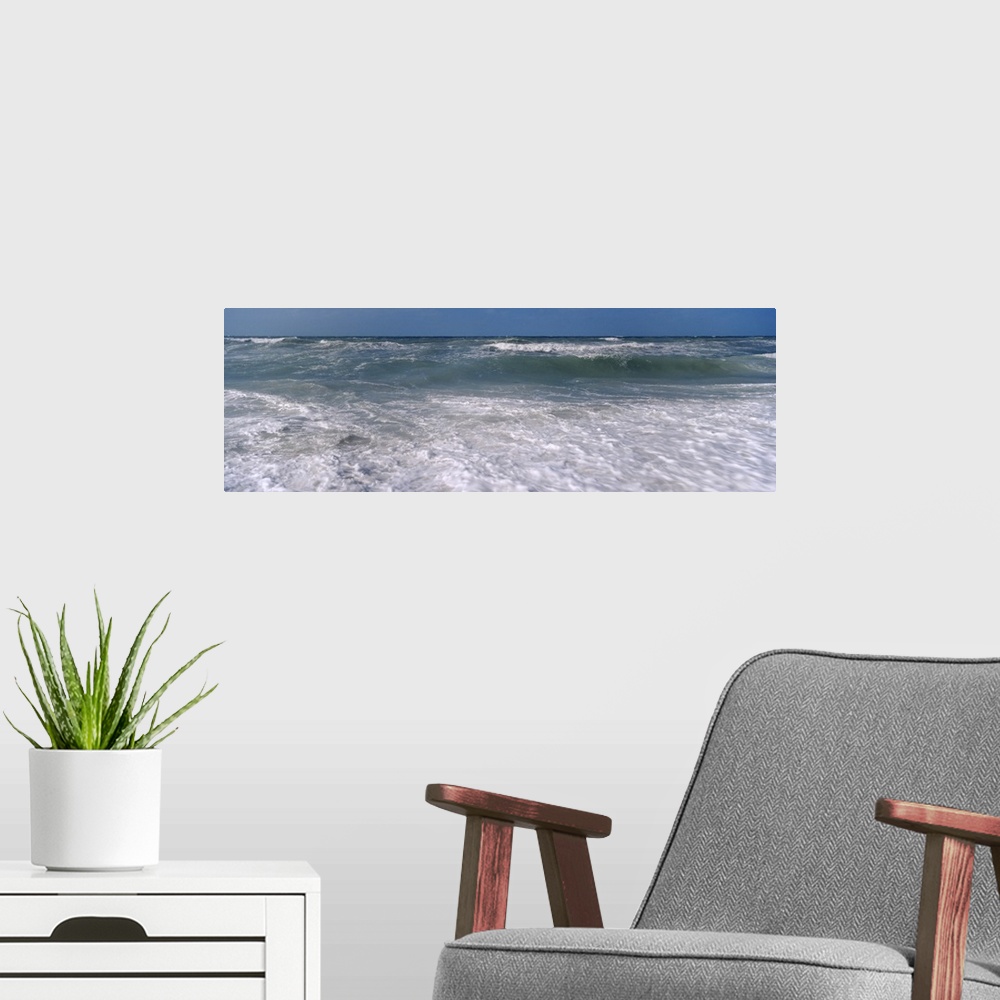 A modern room featuring Waves break just of shore in this panoramic photograph of a Gulf Coast beach.