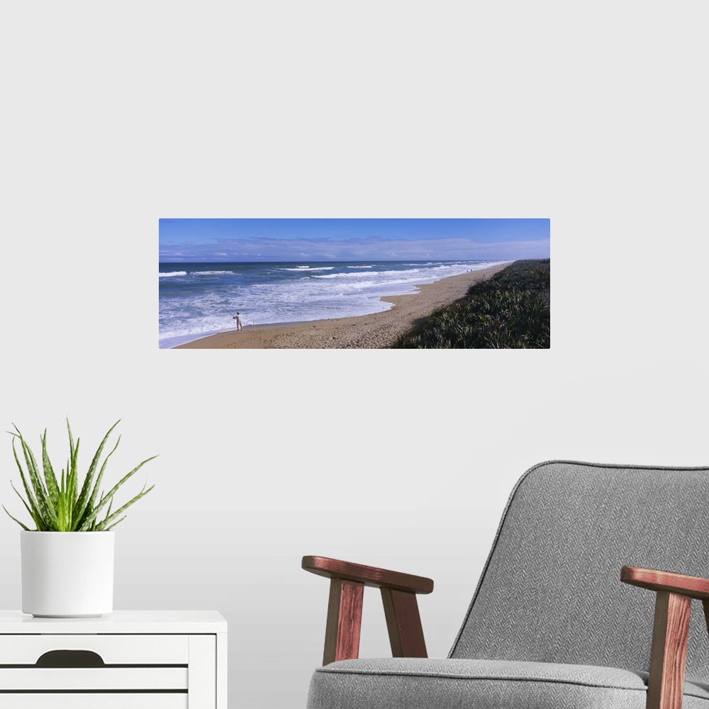 A modern room featuring High angle view of a person fishing on the beach, Playalinda Beach, Canaveral National Seashore, ...