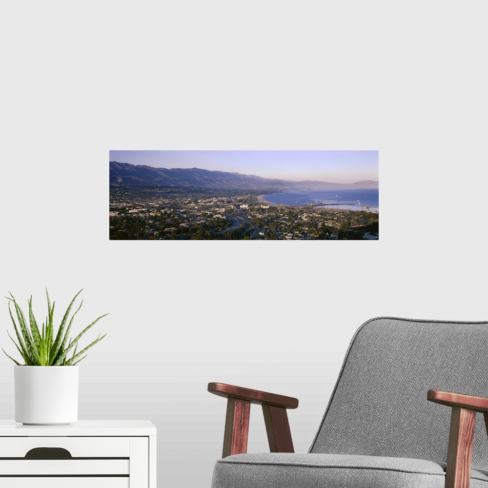 A modern room featuring Panoramic photo print of the Pacific Ocean meeting Santa Barbara and the rolling mountains in the...