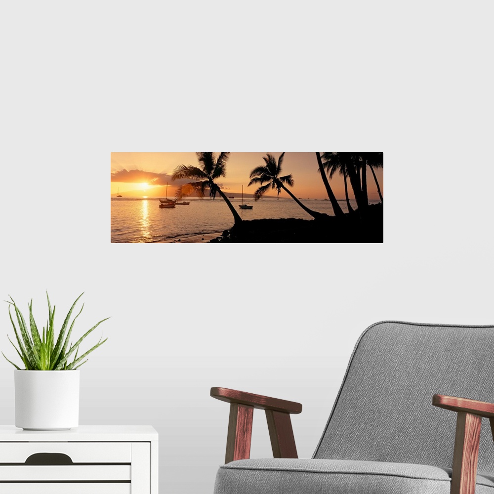 A modern room featuring Panoramic photograph of a colorful sunset in the town of Lahaina on the island of Maui in Hawaii....