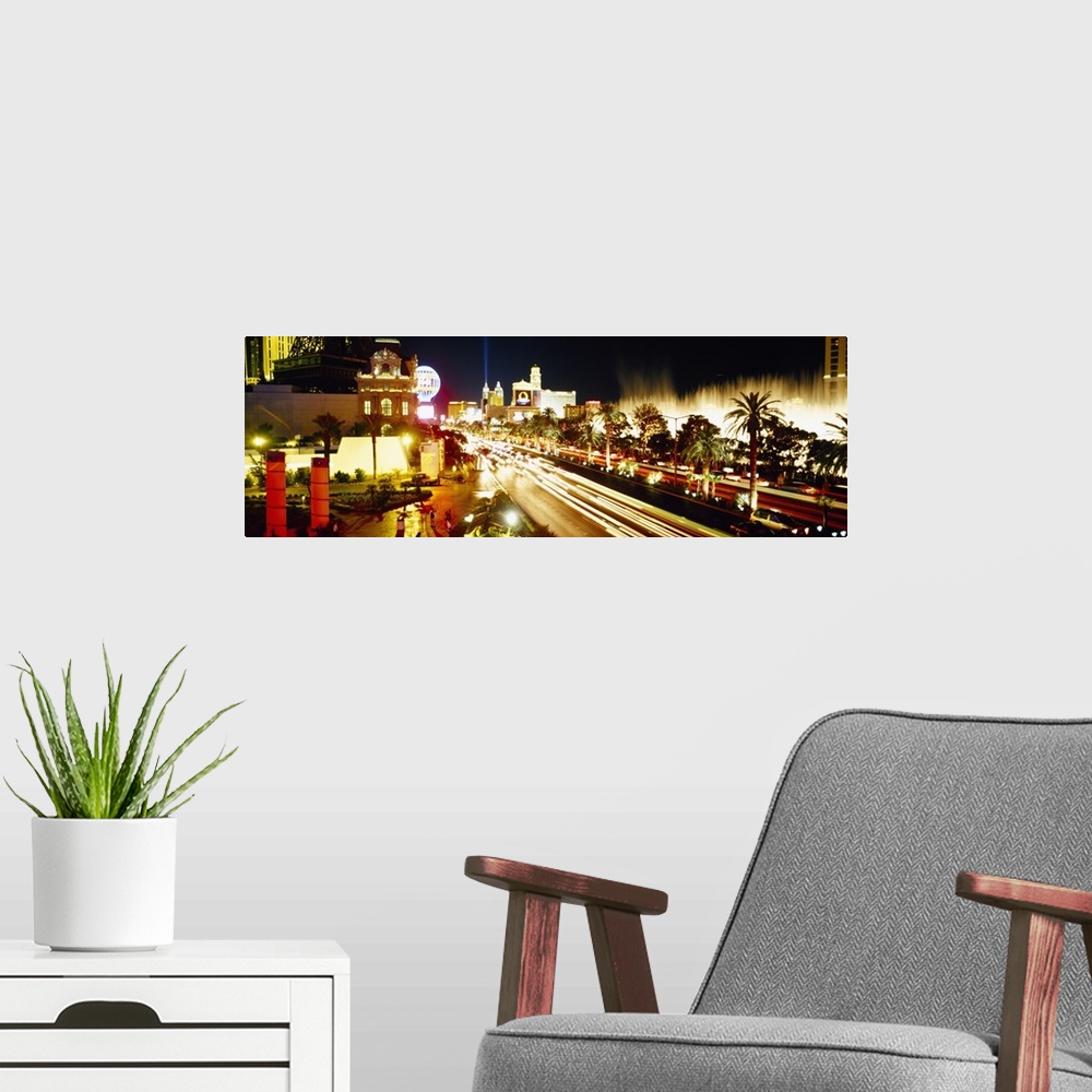 A modern room featuring Panoramic photograph of light trails from cars driving down the Las Vegas strip, bright lights sh...