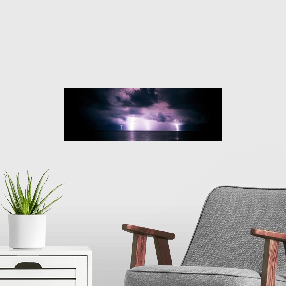 A modern room featuring Panoramic photograph of a dark, stormy sky, several bright lightening bolts striking the horizon ...