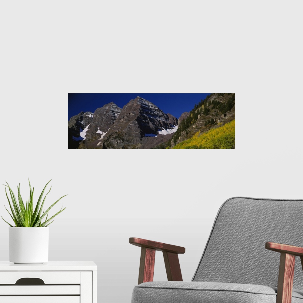 A modern room featuring Panoramic photo print of a rugged mountain range up close.