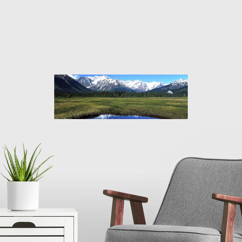 A modern room featuring Mountain scene with lake, distant hotel, Moose Meadow, Alaska