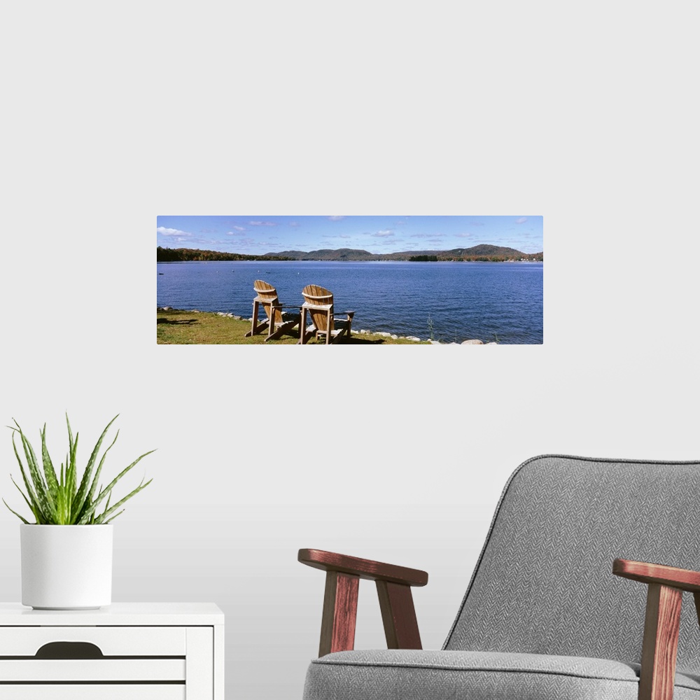 A modern room featuring New York State, Adirondack Mountains, Fourth Lake, Chairs on a lawn