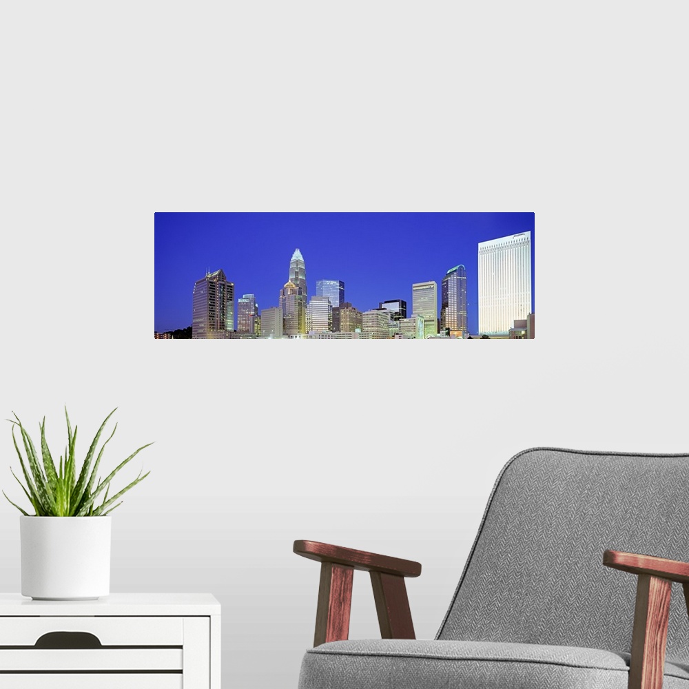 A modern room featuring A night cityscape panorama of Charlotte, North Carolina.