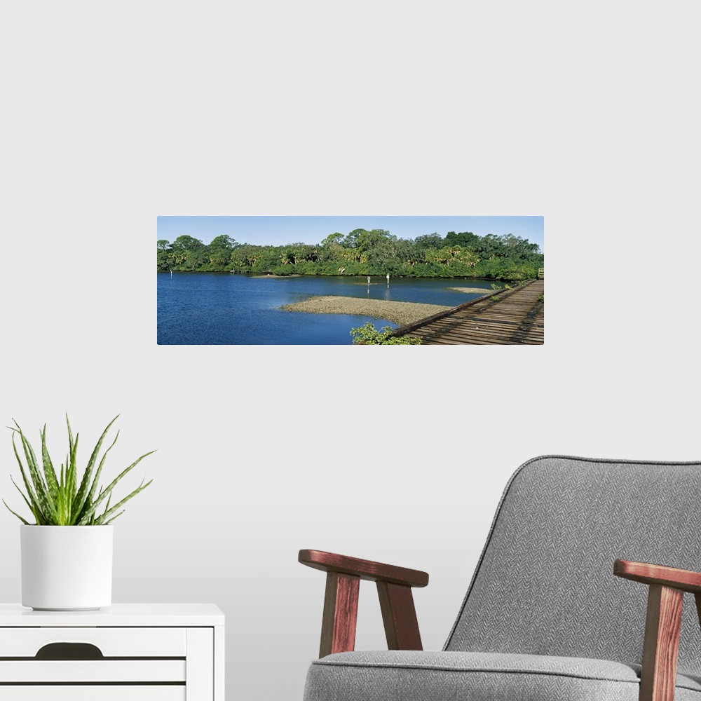 A modern room featuring Old railroad trestle across a shallow bay at low tide showing oyster beds, Nokomis, Sarasota Coun...