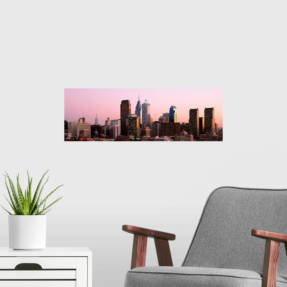 A modern room featuring The skyline of Philadelphia, Pennsylvania against a hazy sunset sky.