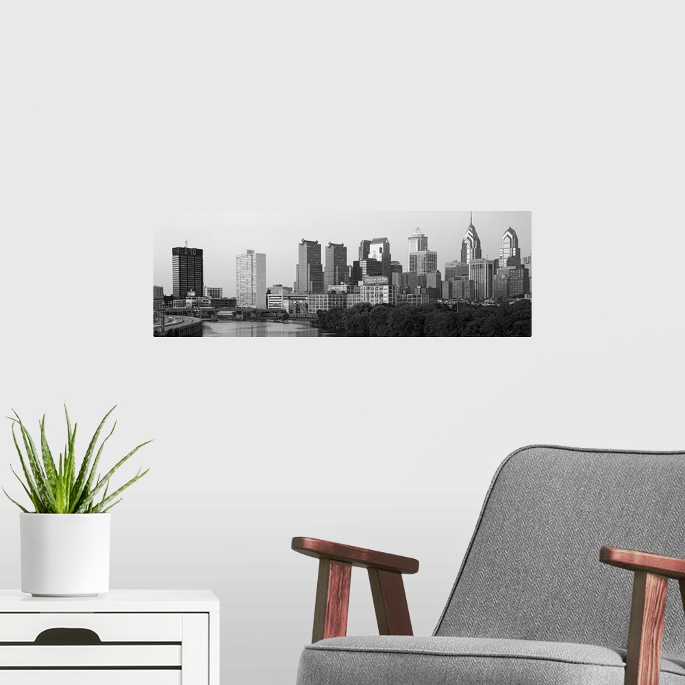 A modern room featuring Panoramic photograph taken in black and white of the skyline in Philadelphia. A highway is seen t...