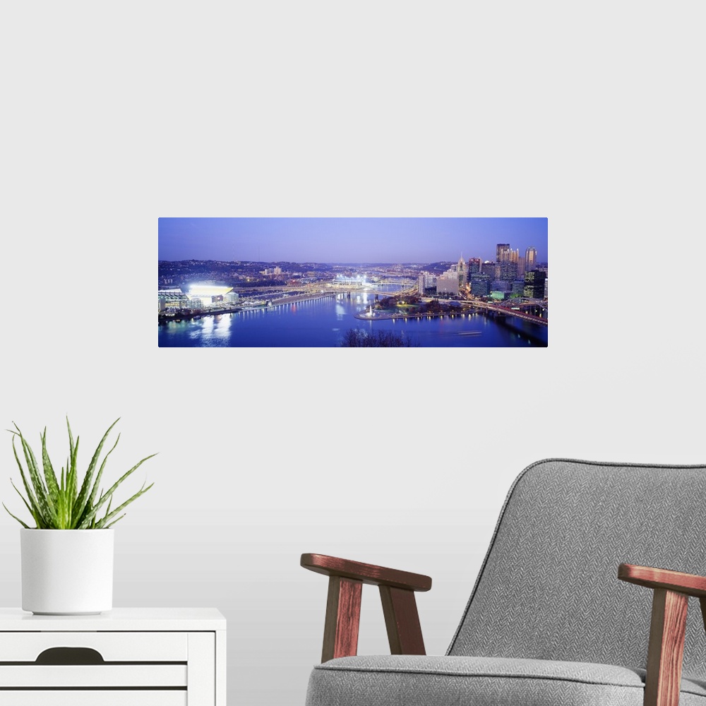 A modern room featuring Panoramic photograph displays an aerial view overlooking the busy skyline of a city within the No...