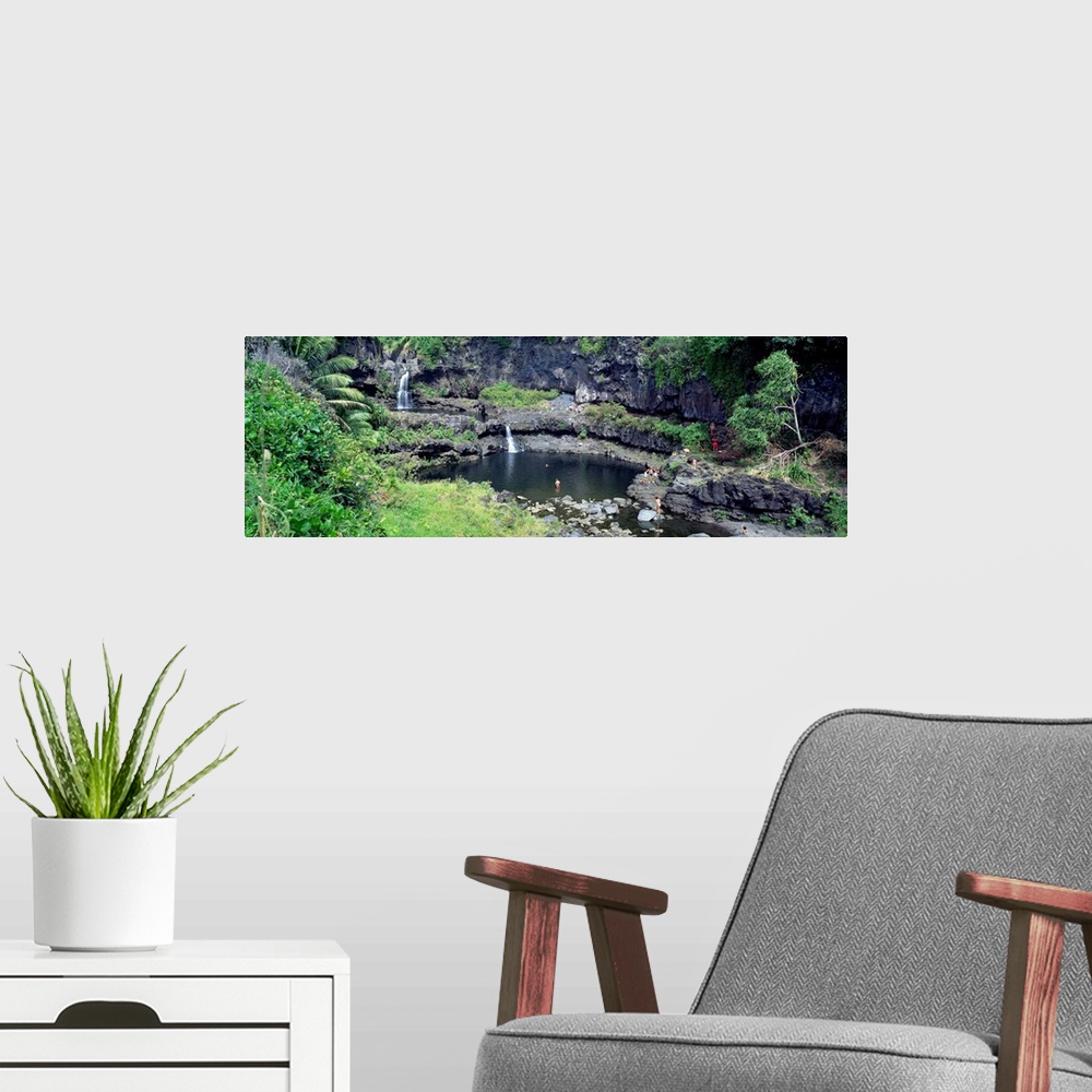 A modern room featuring This large panoramic piece is a photograph taken of small waterfalls that go into a pool of water...